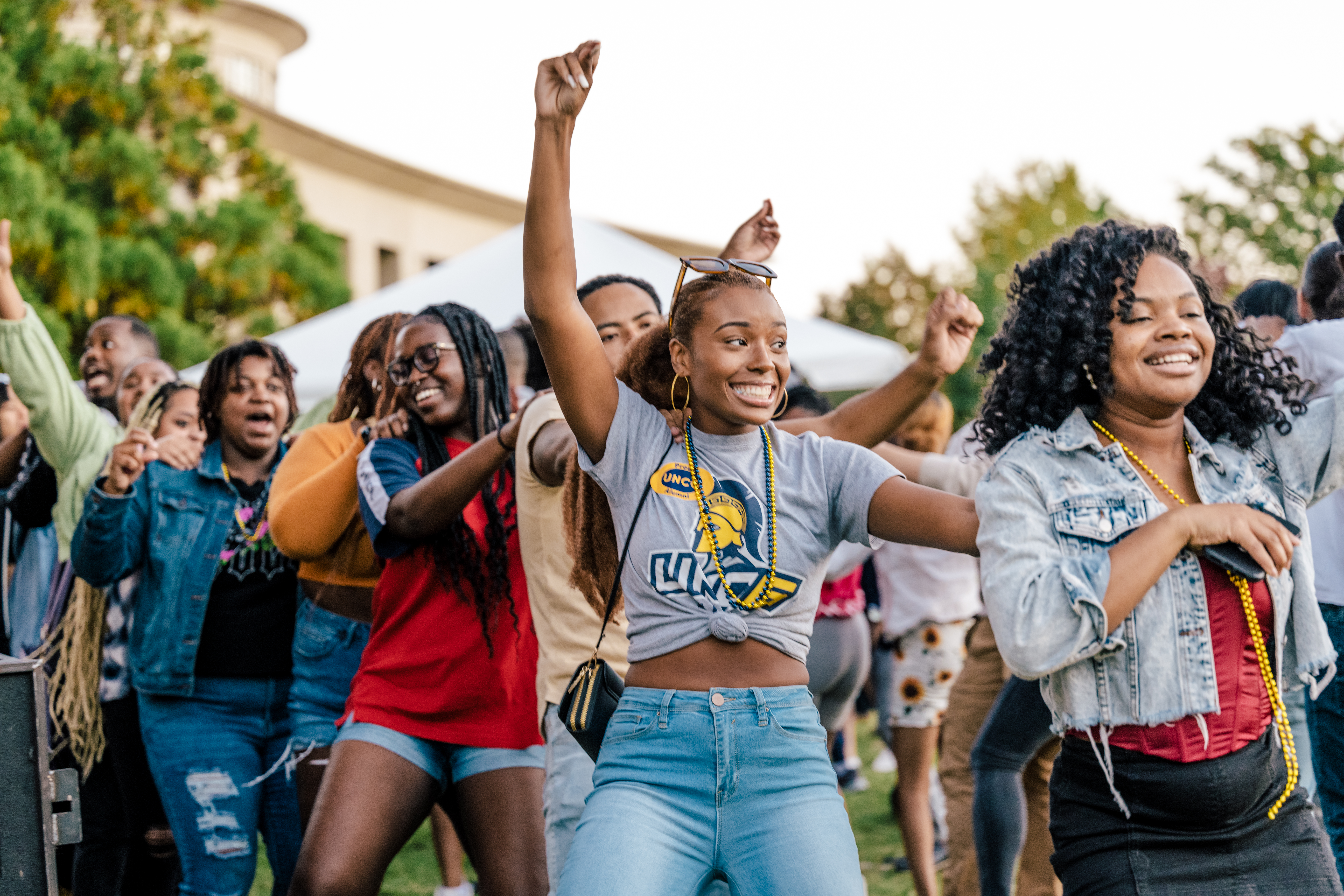 A diverse group of students dancing outside of the Elliott University Center. 